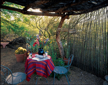 Southwestern Native Americans build what the Spaniards called ramadas to extend their living spaces outside. The simple, elegant, open-air structures are constructed with native wood and use cut vines for privacy and wind protection. This ramada, in Tucson, provides shade and privacy for outdoor dining.